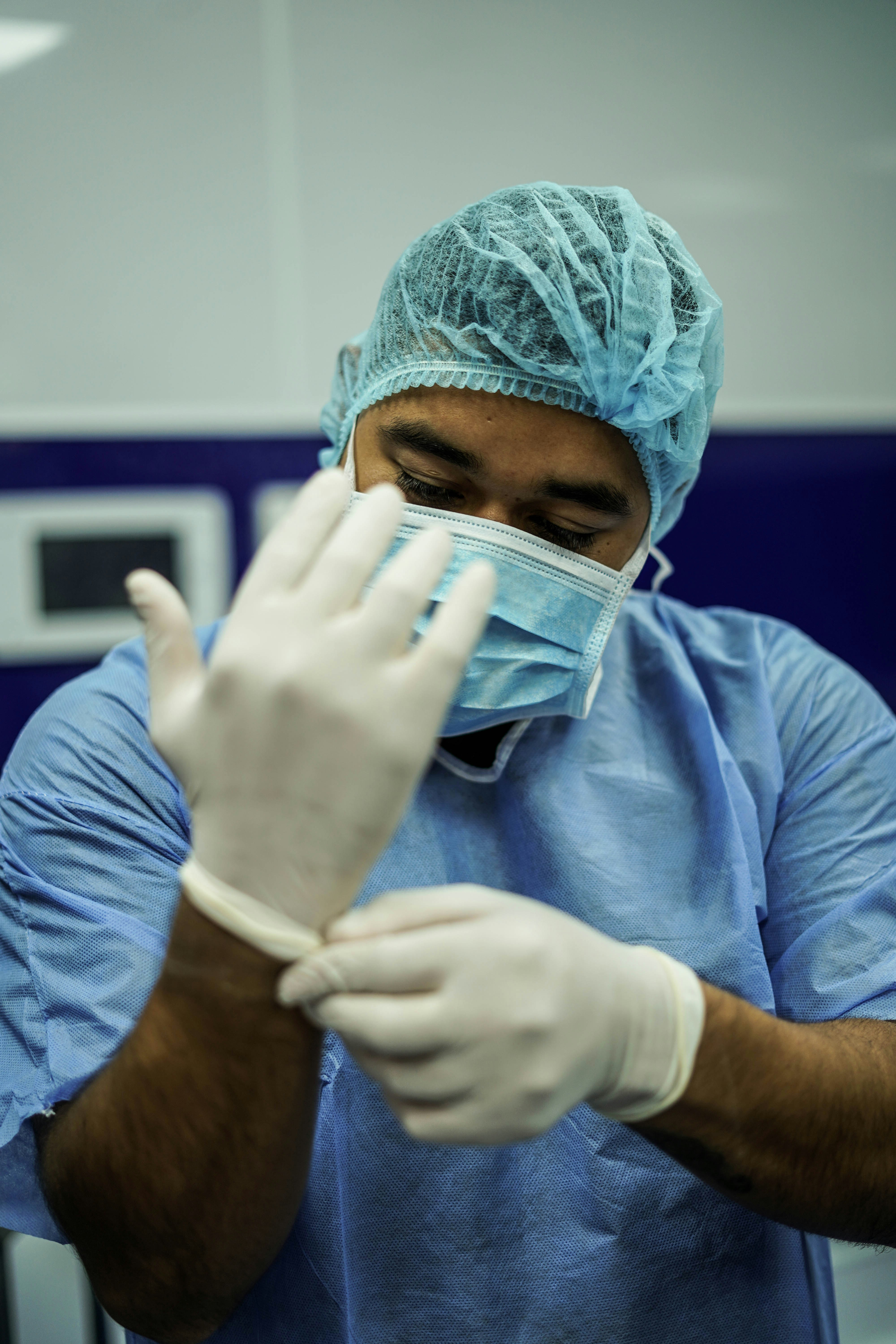 A Image showing a male and female nurse in blue srubs standing together
